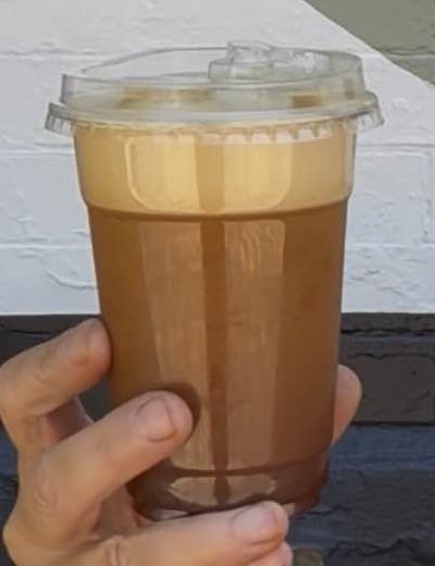 Compass Point’s Aerocano, an iced espresso drink with a foamy top in a clear lidded cup